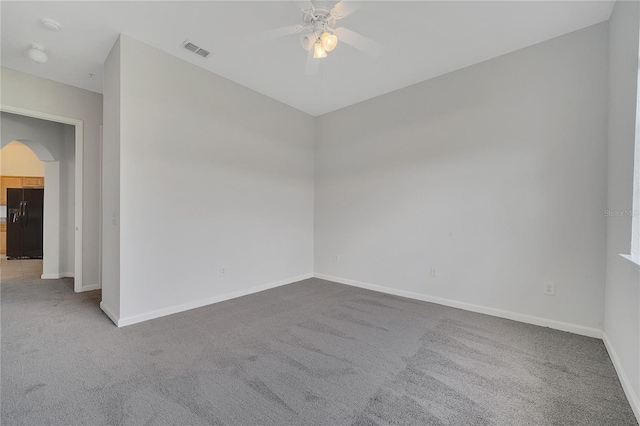 empty room featuring ceiling fan and carpet flooring