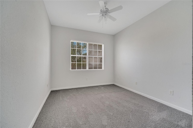 spare room with ceiling fan and carpet flooring