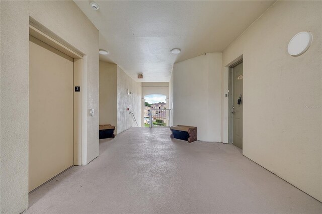 hallway with a textured ceiling