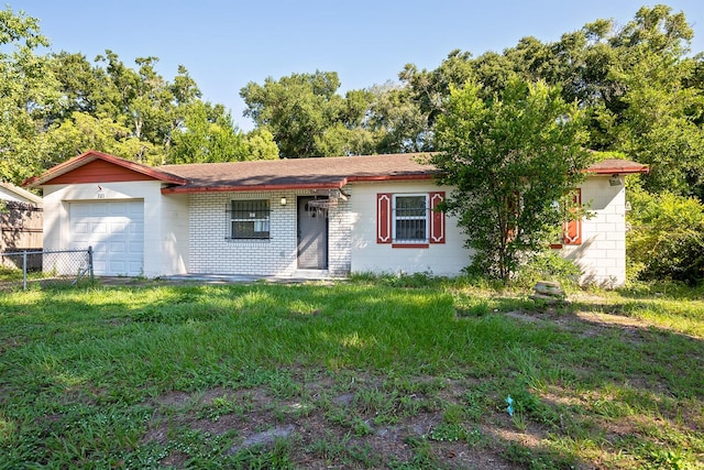 ranch-style house with a garage and a front lawn