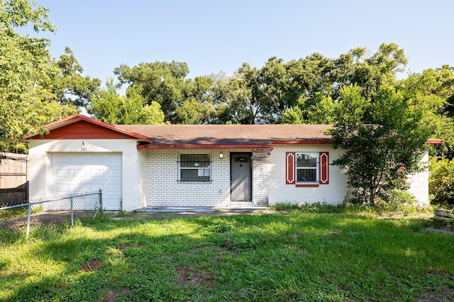 single story home with a garage and a front yard