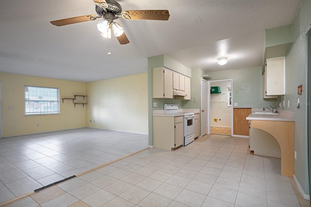 kitchen featuring light tile patterned floors, a textured ceiling, ceiling fan, white range with electric cooktop, and sink