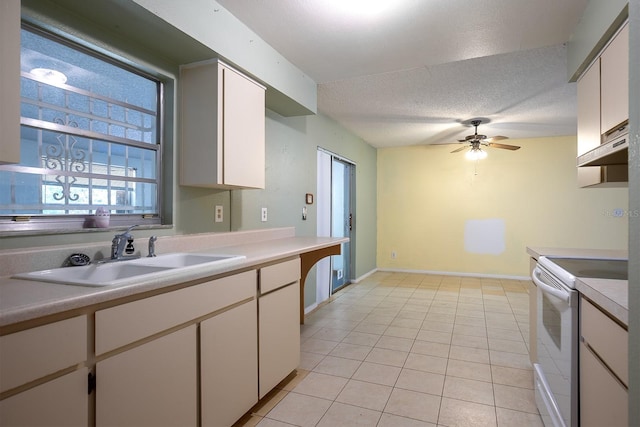 kitchen with white cabinetry, light tile patterned floors, white electric stove, a textured ceiling, and sink