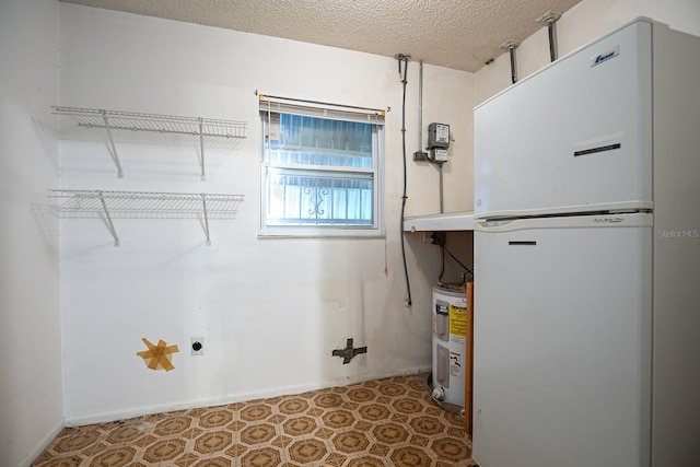 washroom with a textured ceiling and electric water heater