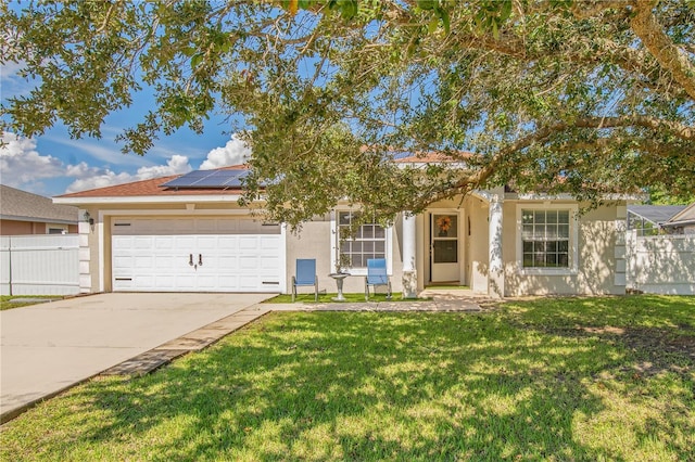 view of front of property featuring solar panels, a front yard, and a garage