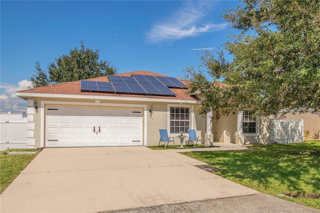 view of front facade featuring solar panels, a garage, and a front lawn