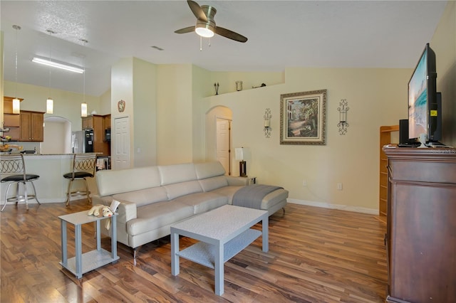 living room featuring ceiling fan, high vaulted ceiling, a textured ceiling, and dark hardwood / wood-style flooring