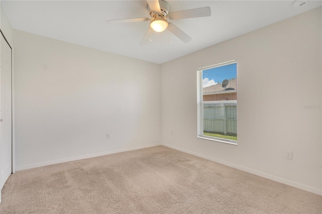 carpeted empty room with ceiling fan