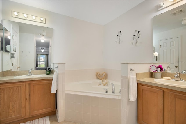 bathroom with vanity, tile patterned flooring, ceiling fan, and tiled bath