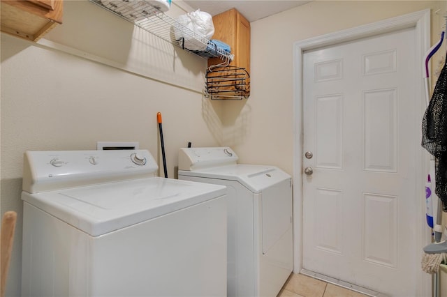 laundry area featuring light tile patterned floors and washing machine and clothes dryer