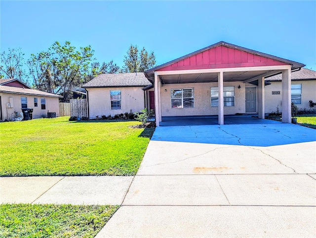 view of front of house featuring a front lawn and a carport