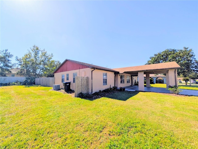 exterior space featuring a front yard and central AC unit