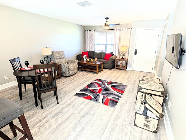 living room featuring wood-type flooring and ceiling fan