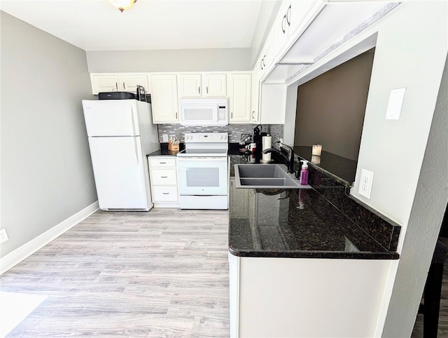 kitchen with sink, light hardwood / wood-style flooring, white appliances, decorative backsplash, and white cabinets