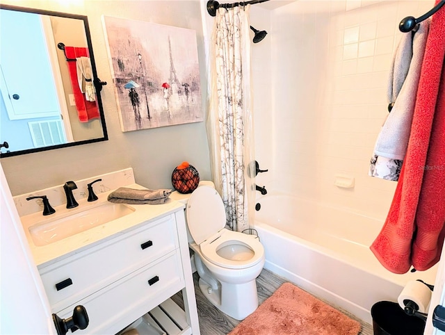 full bathroom with shower / bath combination with curtain, vanity, and toilet