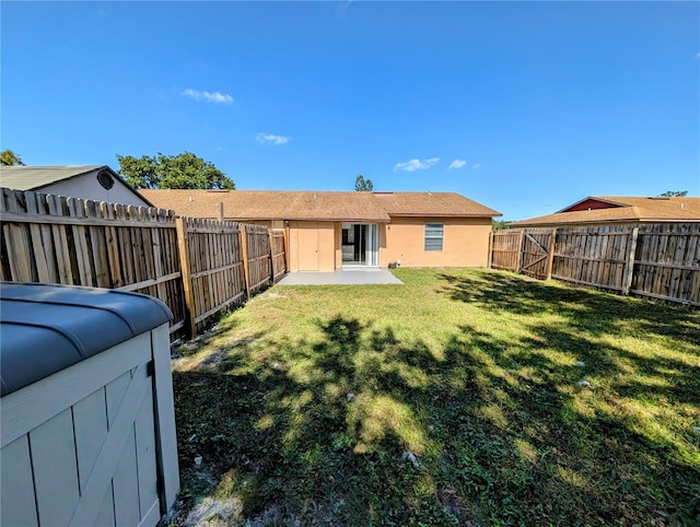 rear view of house with a yard and a patio