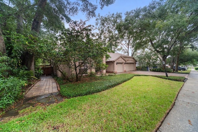 exterior space with a garage and a front lawn