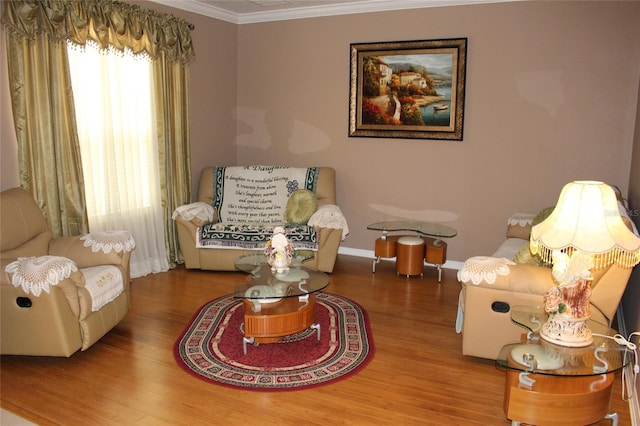 sitting room featuring ornamental molding and hardwood / wood-style flooring