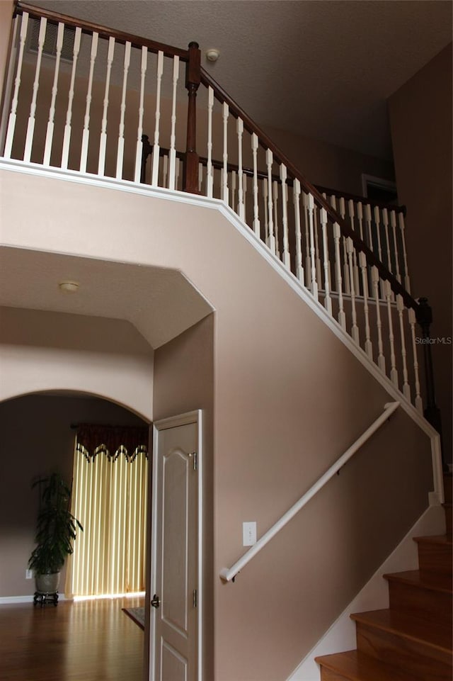 stairway featuring wood-type flooring