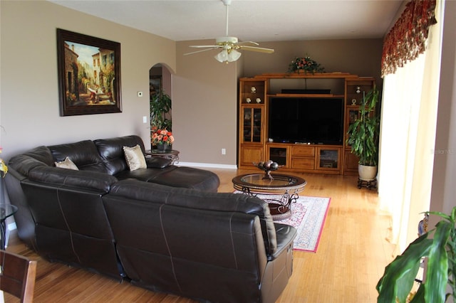 living room featuring ceiling fan and light hardwood / wood-style flooring