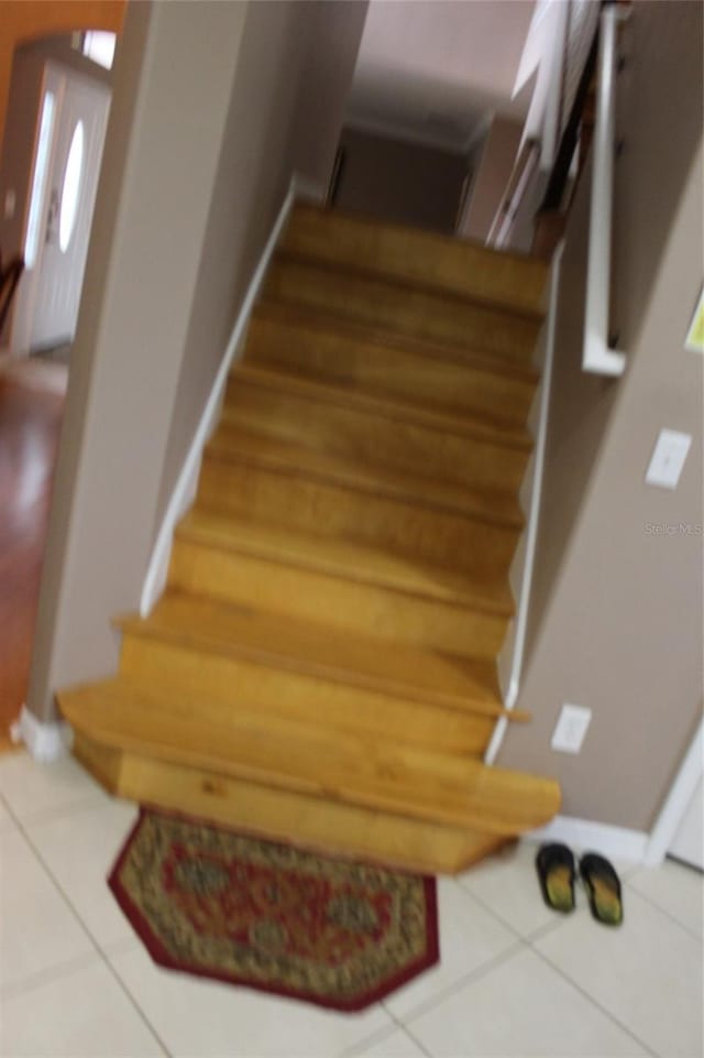 staircase with tile patterned floors