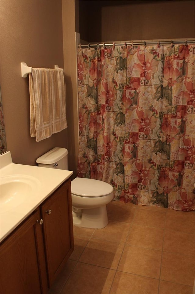 bathroom featuring a shower with curtain, tile patterned floors, vanity, and toilet