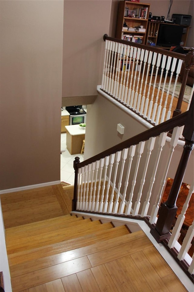 stairs with hardwood / wood-style floors