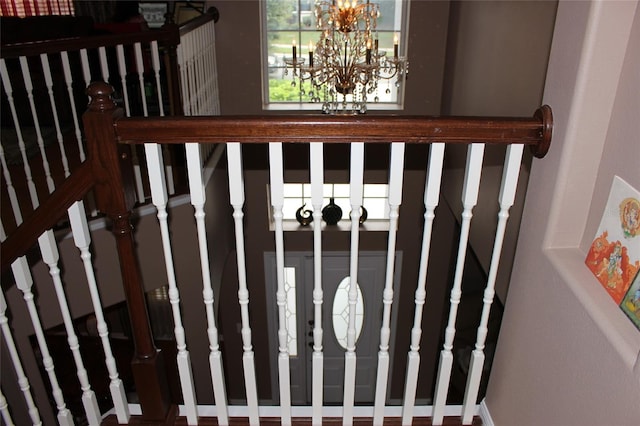 staircase featuring a notable chandelier