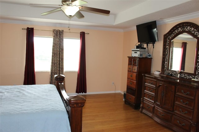 bedroom with ornamental molding, ceiling fan, and light hardwood / wood-style floors