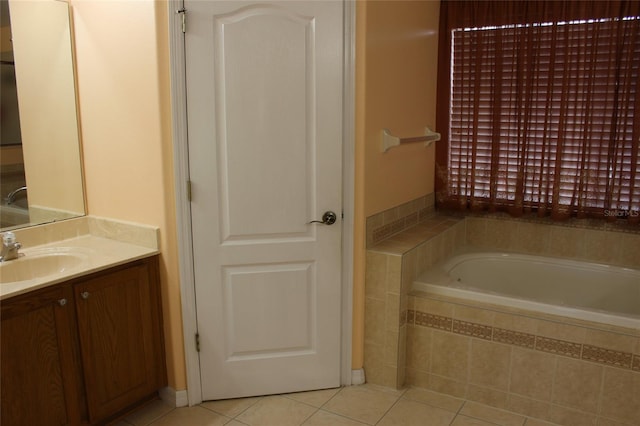 bathroom featuring vanity, tiled bath, and tile patterned flooring