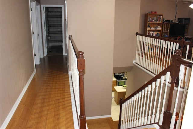 hallway with hardwood / wood-style floors