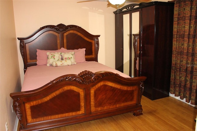 bedroom featuring ceiling fan and light hardwood / wood-style floors