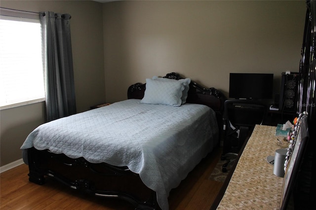 bedroom with hardwood / wood-style flooring