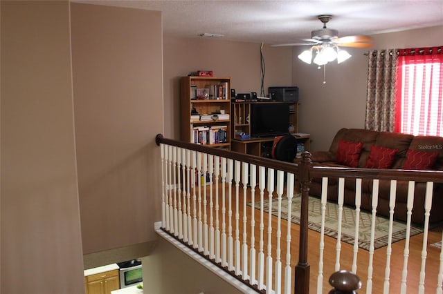 interior space featuring ceiling fan, hardwood / wood-style floors, and a textured ceiling