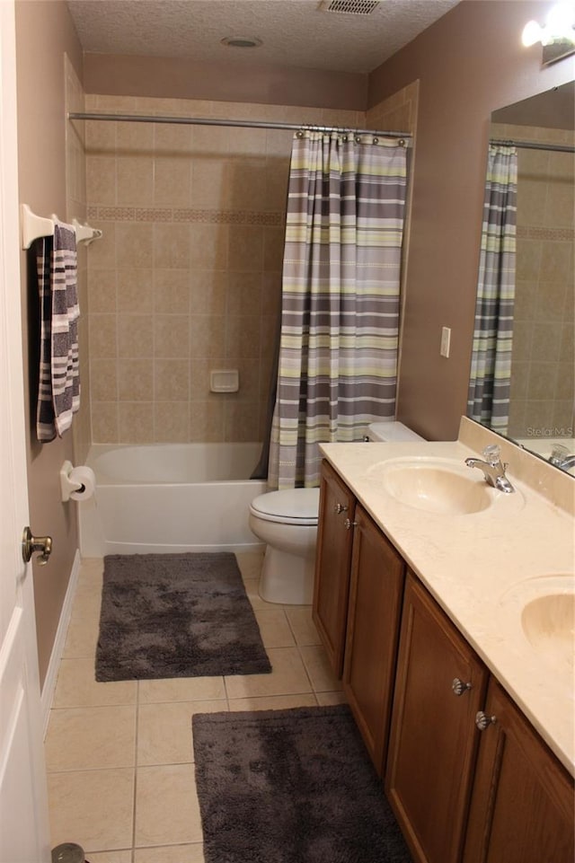 full bathroom with shower / bath combo, vanity, toilet, and a textured ceiling