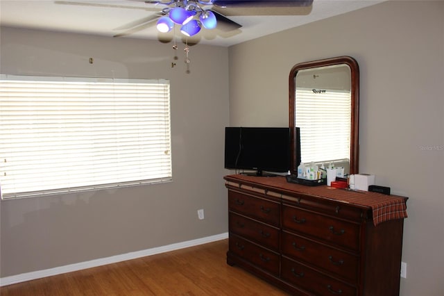 bedroom with ceiling fan and light hardwood / wood-style flooring