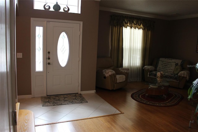 foyer with light hardwood / wood-style floors and ornamental molding