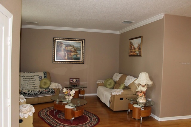 living room featuring hardwood / wood-style flooring, crown molding, and a textured ceiling