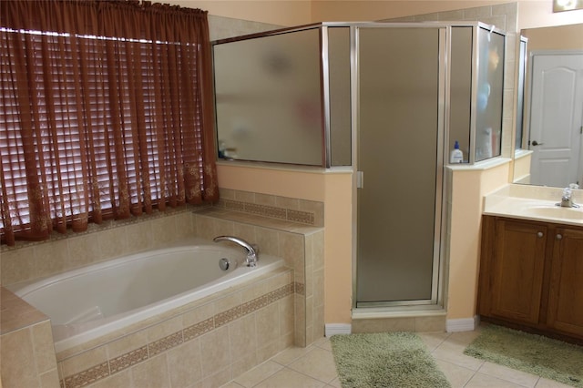 bathroom featuring tile patterned floors, separate shower and tub, and vanity