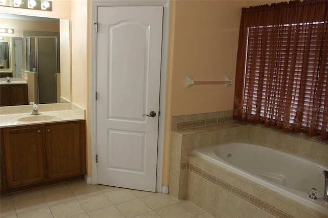 bathroom featuring tile patterned flooring, separate shower and tub, and vanity