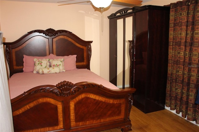 bedroom with hardwood / wood-style flooring and ceiling fan