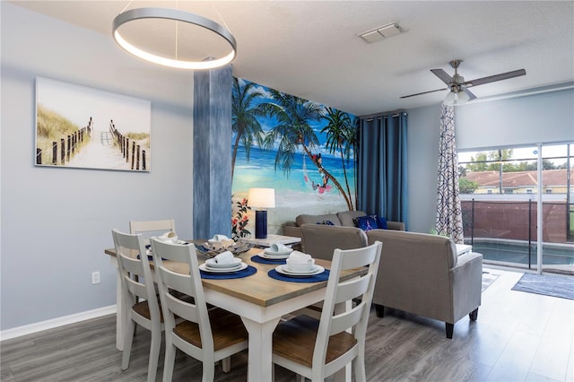 dining space with a textured ceiling, wood-type flooring, and ceiling fan