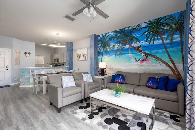 living room featuring light hardwood / wood-style flooring and ceiling fan