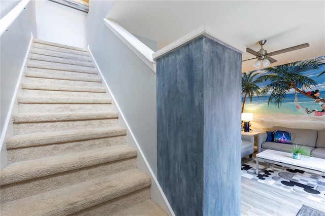 3052 Secret Lake Dr, Kissimmee, FL 34747 - stairway with a ceiling fan and wood finished floors