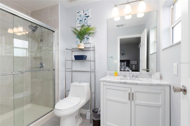 bathroom with an enclosed shower, vanity, and toilet