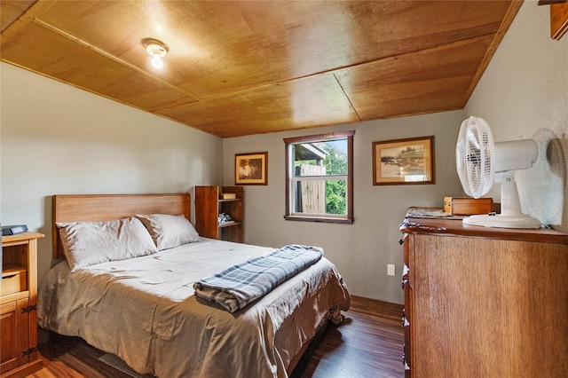 bedroom with wooden ceiling and dark wood-type flooring