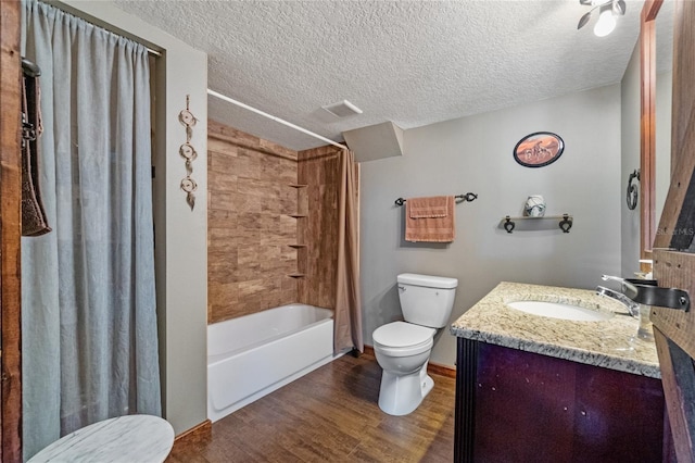 full bathroom featuring vanity, toilet, shower / bathtub combination with curtain, a textured ceiling, and wood-type flooring