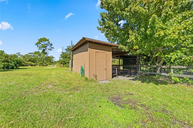 view of outdoor structure featuring a lawn