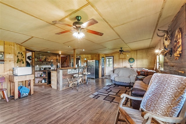 living room with wood walls and hardwood / wood-style floors