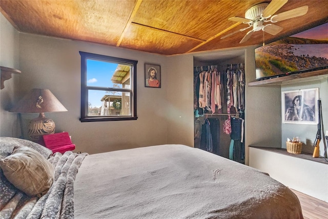 bedroom with ceiling fan, a closet, wooden ceiling, and wood-type flooring